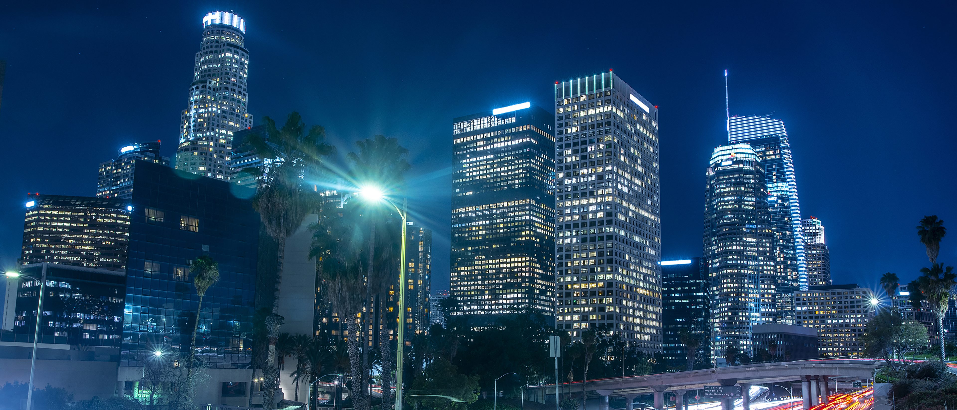 City skyline at night with buildings lit up